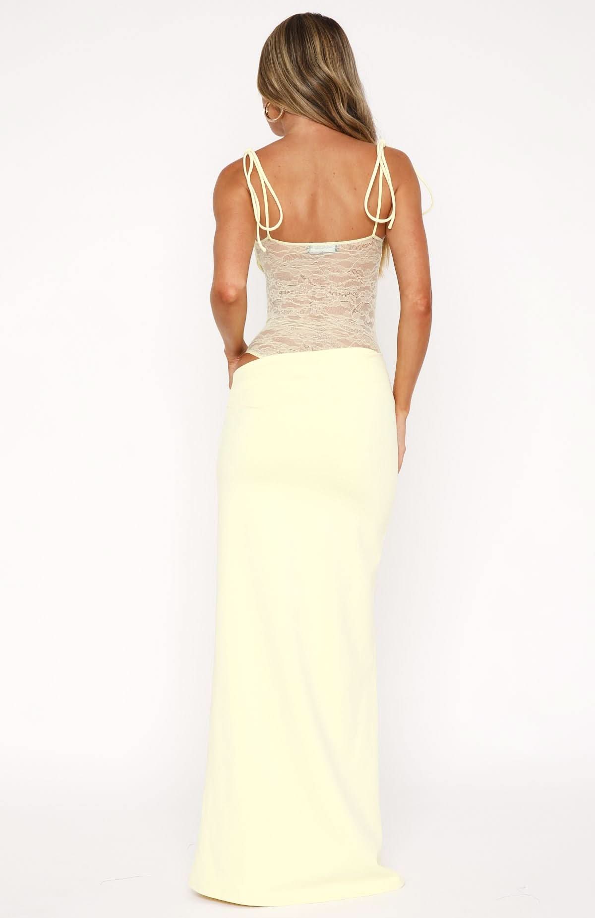 Back view of cream maxi dress showing lace panel and tie shoulder straps
