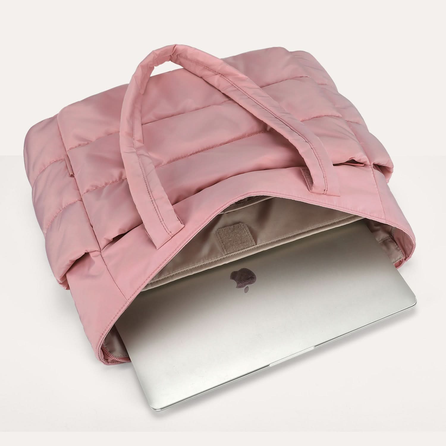 Pink puffed tote with open top showing laptop compartment and interior organization