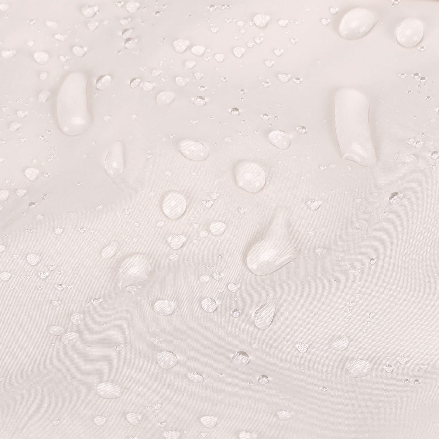 Water beading on cream tote fabric surface showing water-resistant coating