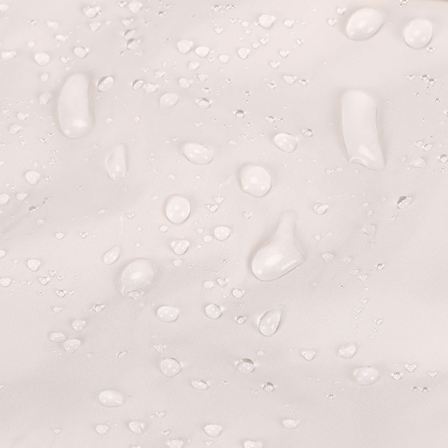 Water beading on cream tote fabric surface showing water-resistant coating
