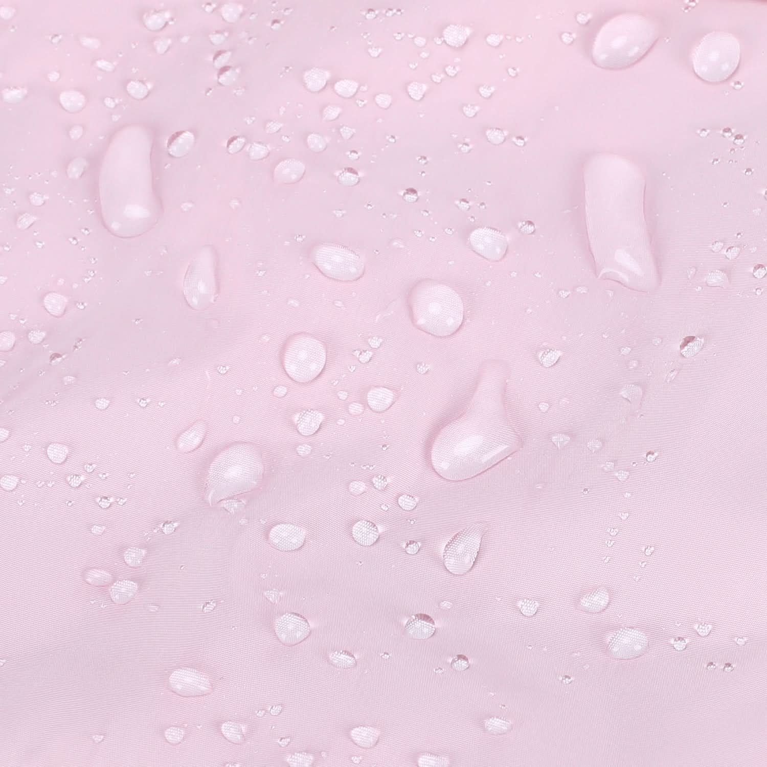 Water droplets beading on pink quilted tote fabric surface