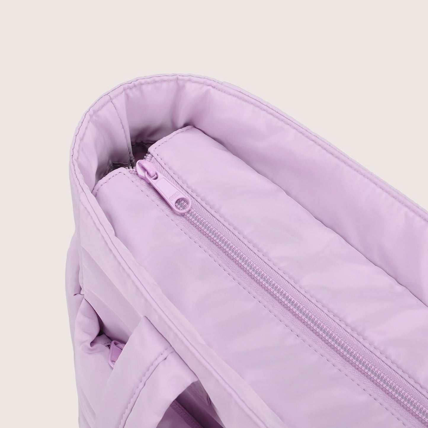 Lavender city tote interior showing main zip pocket and slip pocket organization