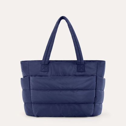 Navy blue padded tote with horizontal quilting and dual handles for daily use