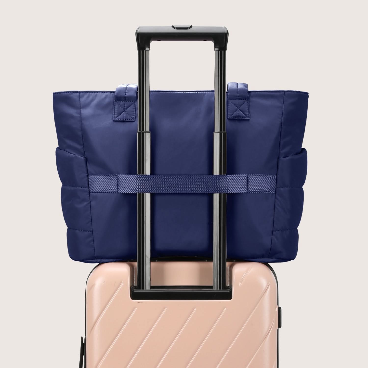 Navy tote with luggage pass-through strap on suitcase handle