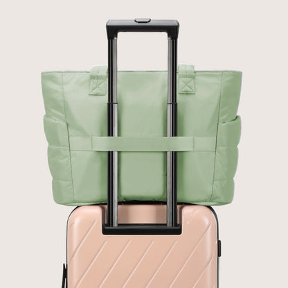 Light green quilted tote attached to suitcase showing luggage pass-through