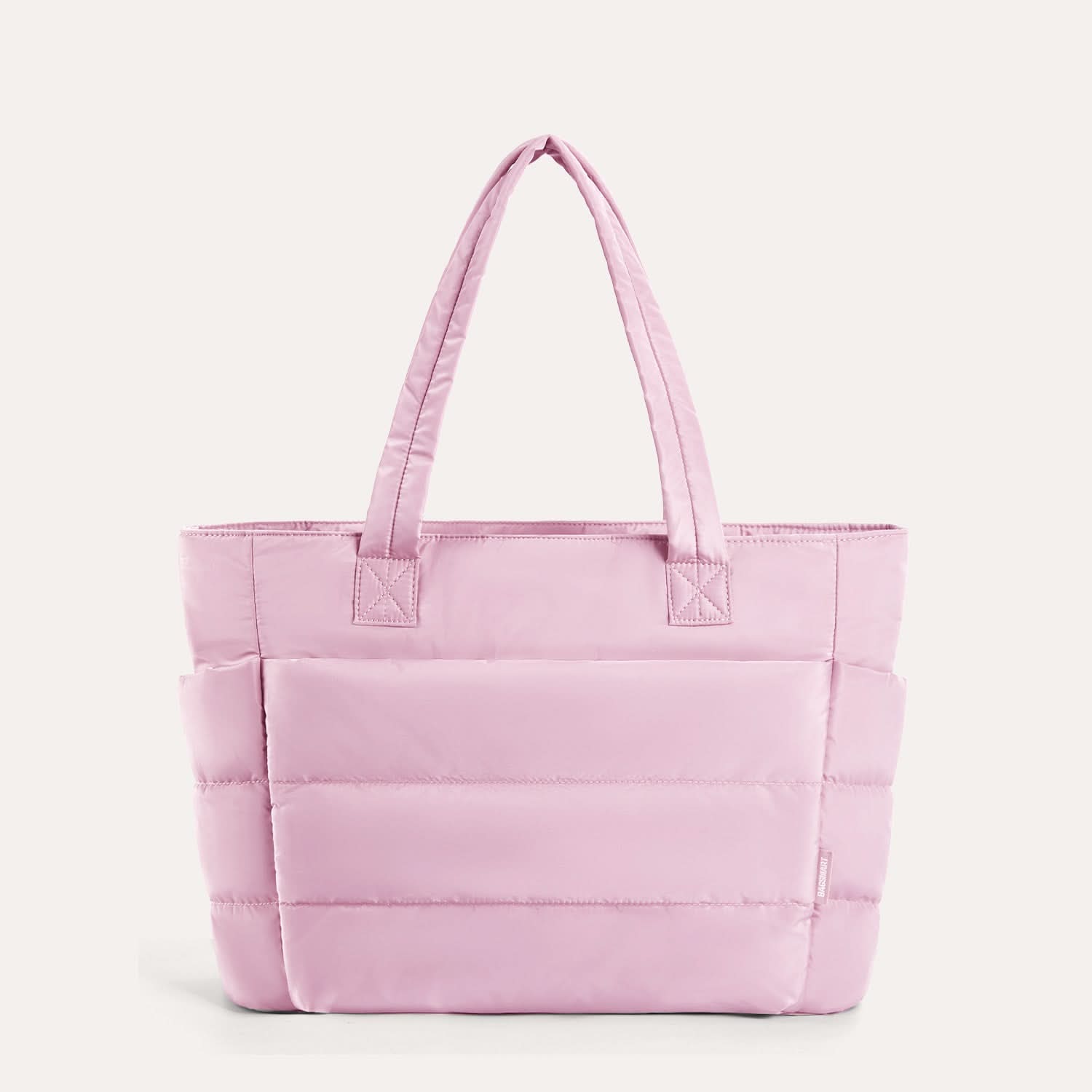 Soft pink quilted laptop tote with structured silhouette