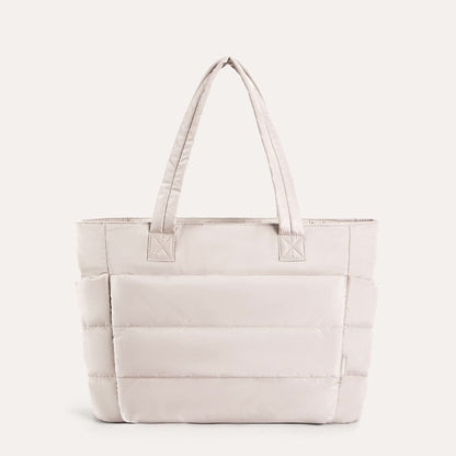Off-white padded tote with quilted sections and dual handles