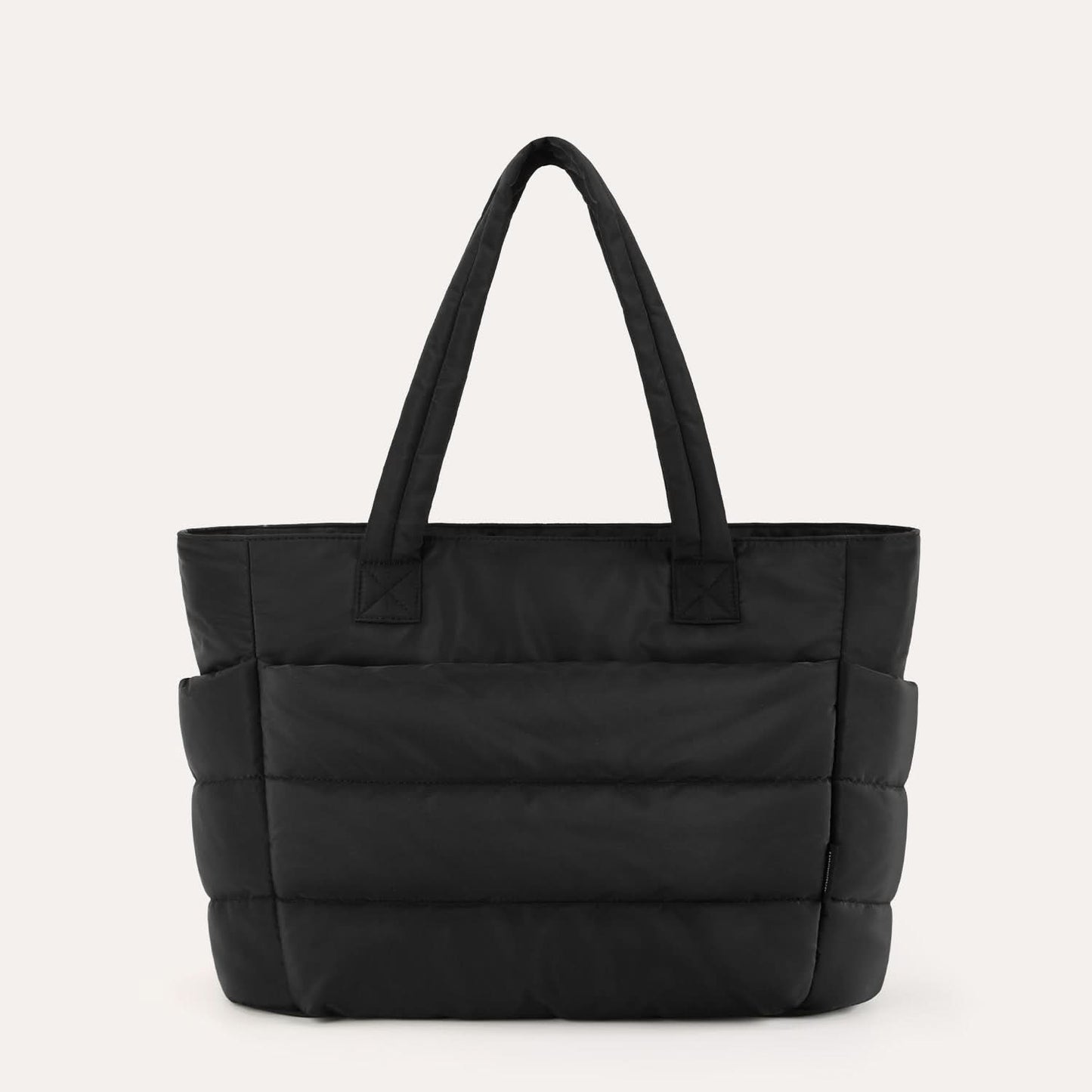 Black quilted city tote with dual handles and padded horizontal sections