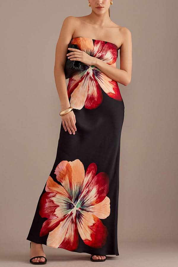 Black satin maxi dress with bold red and coral floral print, strapless cut