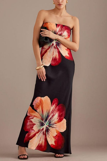 Black satin maxi dress with bold red and coral floral print, strapless cut