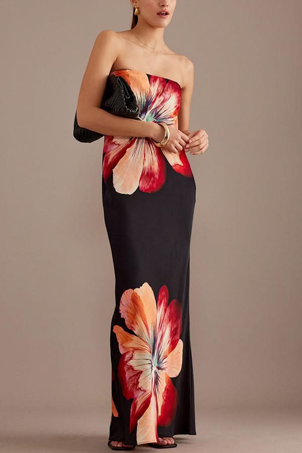 Front view of black satin maxi dress with large red and peach flower motifs
