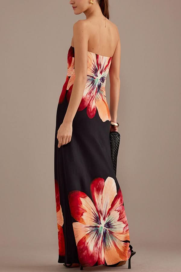 Back view of black satin maxi dress with red floral print and open back