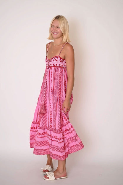 Women's pink bohemian maxi dress side view showing smocked bodice and layered tiers