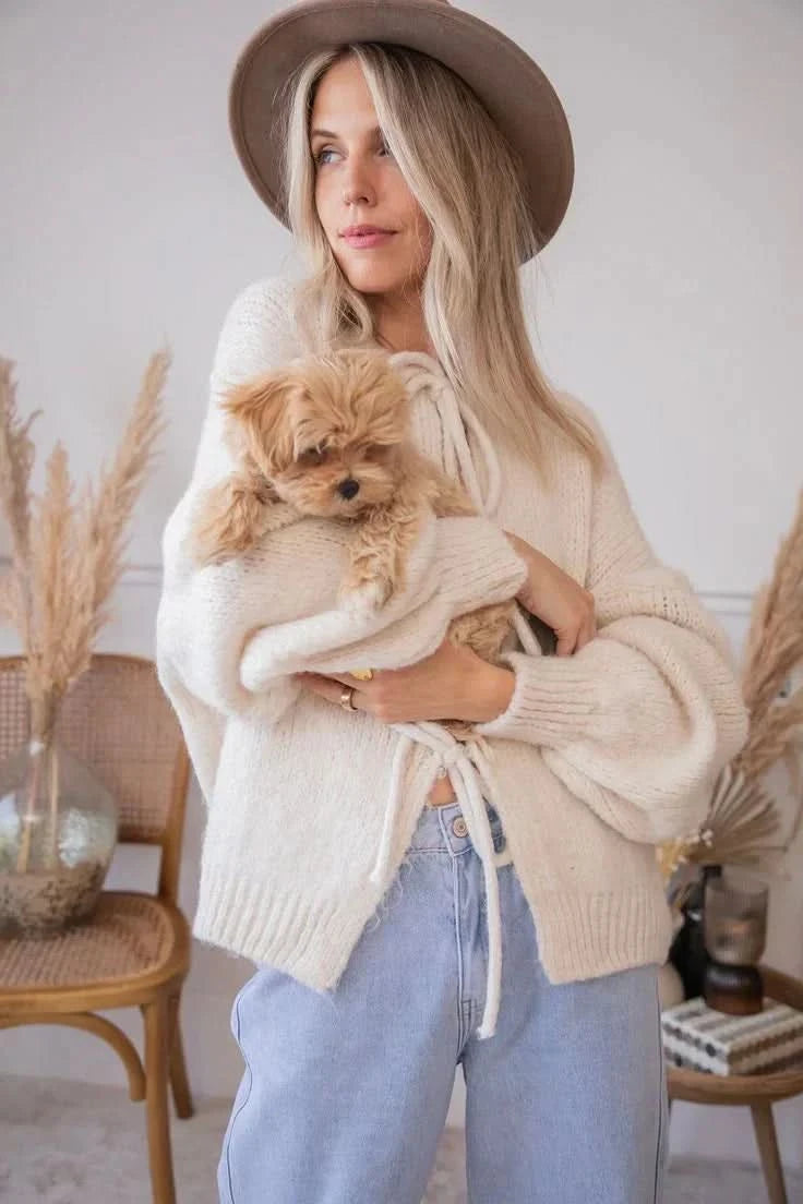 Cream cardigan with tie-front closure and relaxed fit, shown from side angle
