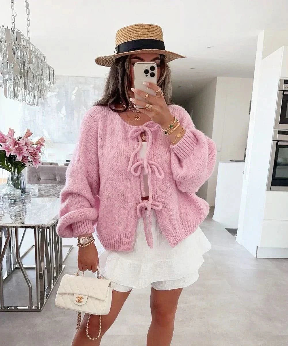 Dusty rose cardigan with oversized silhouette and decorative bow front closure