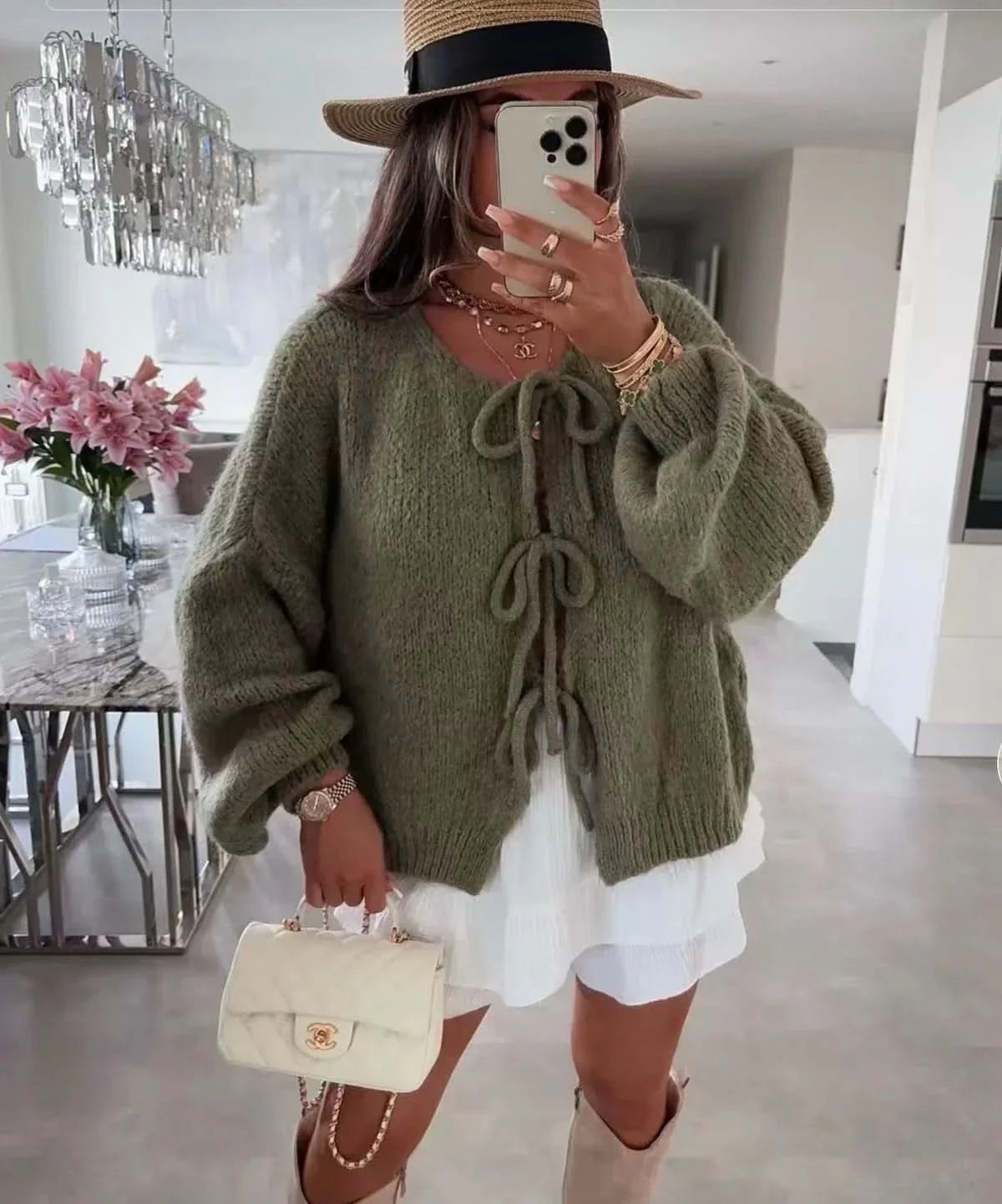 Sage green knit cardigan with puffy sleeves and front tie detail