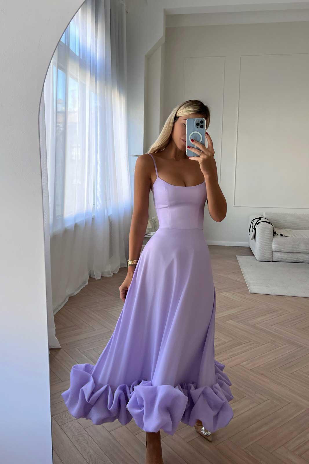 Lavender sleeveless midi dress with ruffled hem and flowing silhouette