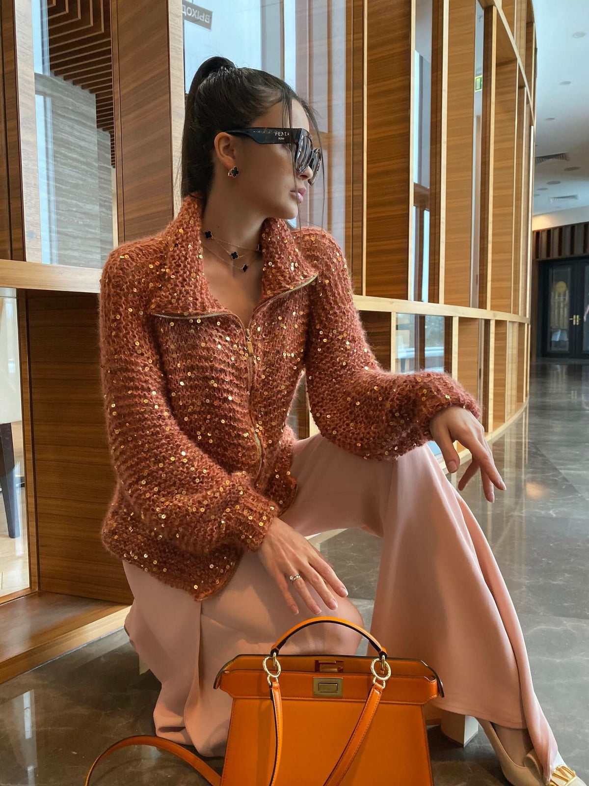 Rust sequin cardigan with zip front and collar, styled over blush skirt