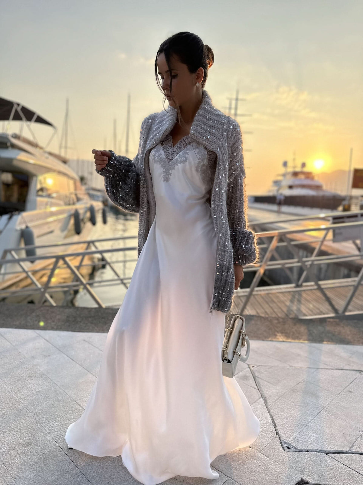Sparkle cardigan with zip front draped over white flowing gown