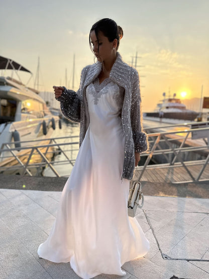Sparkle cardigan with zip front draped over white flowing gown