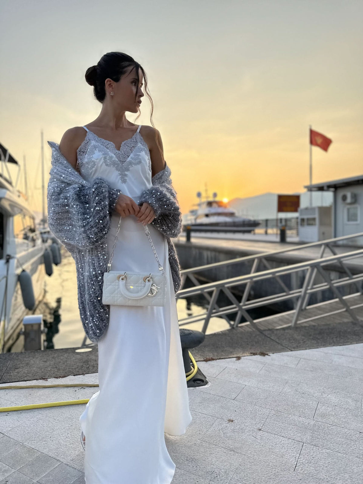 Silver sequined cardigan with wide sleeves paired with white slip dress