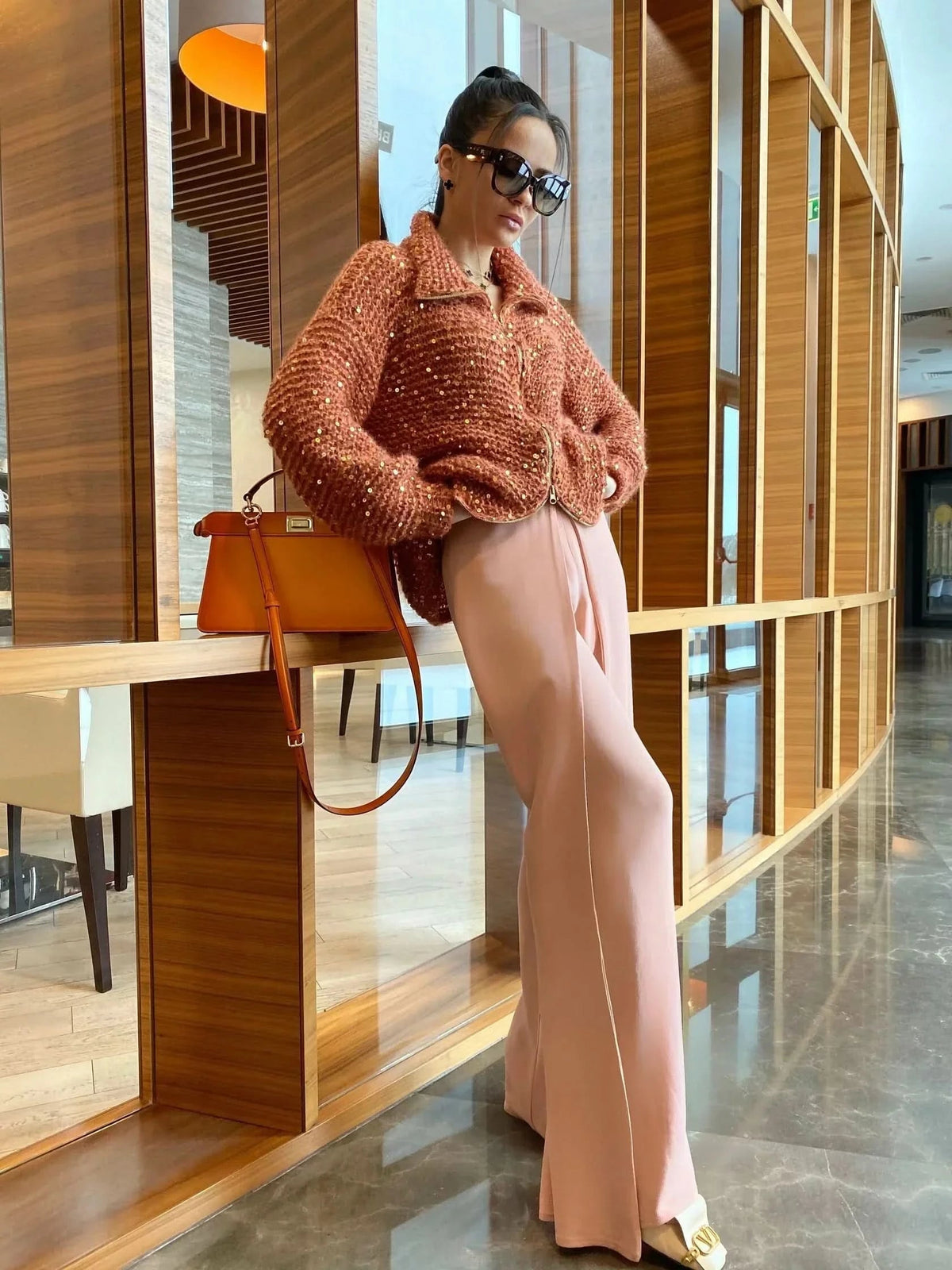 Rust-toned sequin cardigan with relaxed silhouette and zip closure