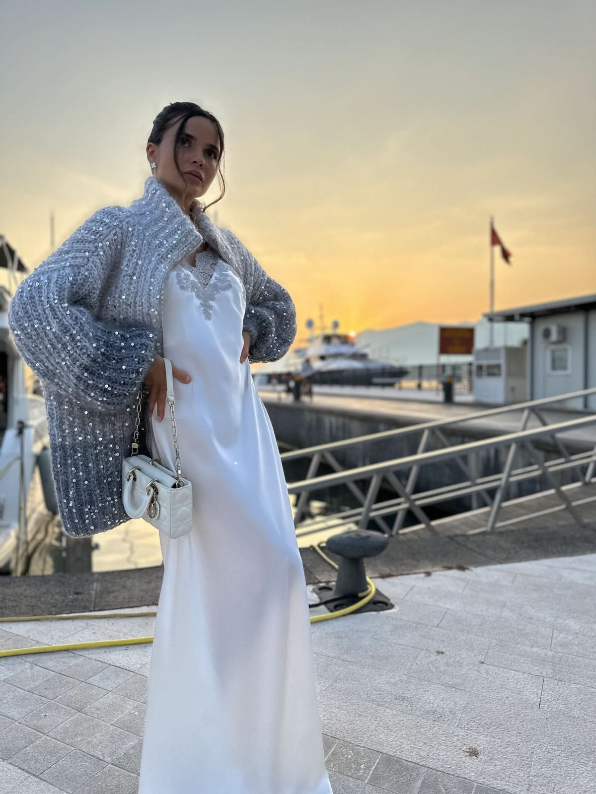 Silver sequin cardigan with collar over white maxi dress at sunset