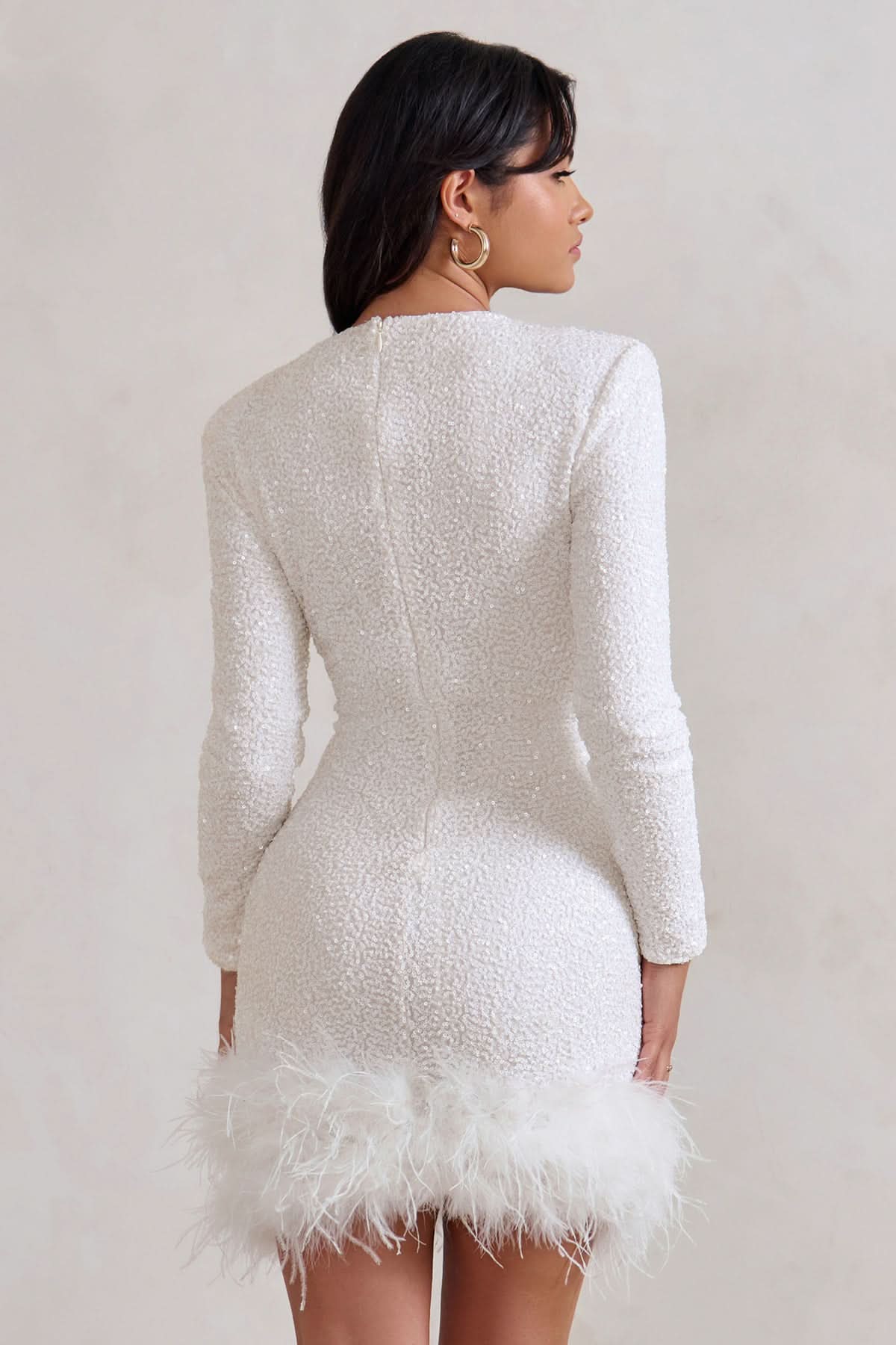Back view of cream sequin mini dress with long sleeves
