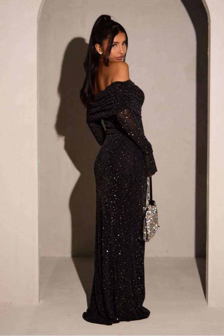 Back view of black sequin maxi dress with draped off-shoulder neckline