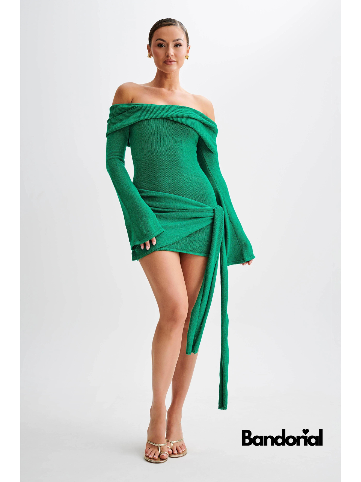 Emerald green off-shoulder mini dress front view with draped tie accent