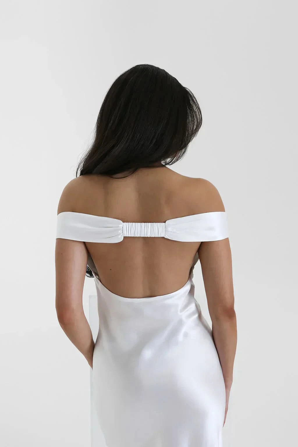 White satin off-shoulder maxi gown with gathered neckline detail