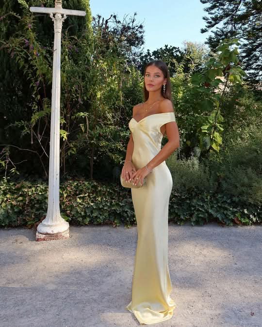 Pale yellow satin maxi dress outdoor styling with garden backdrop