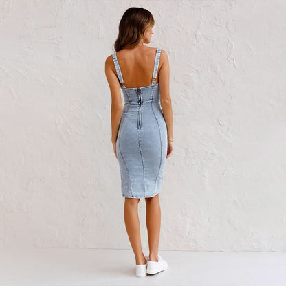 Back view of light blue denim midi dress with adjustable straps and zip detail