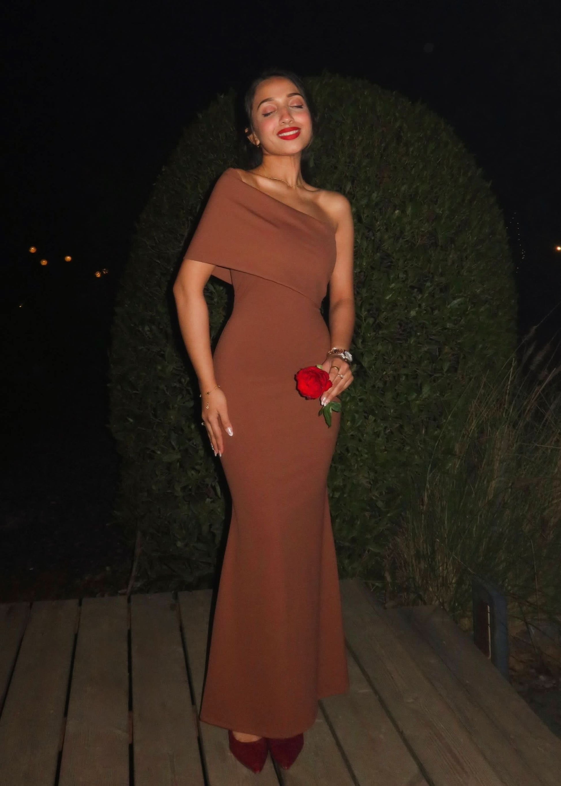Caramel one-shoulder maxi dress with draped neckline and fitted silhouette