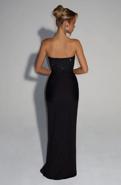 Back view of black beaded strapless maxi gown with flowing silhouette