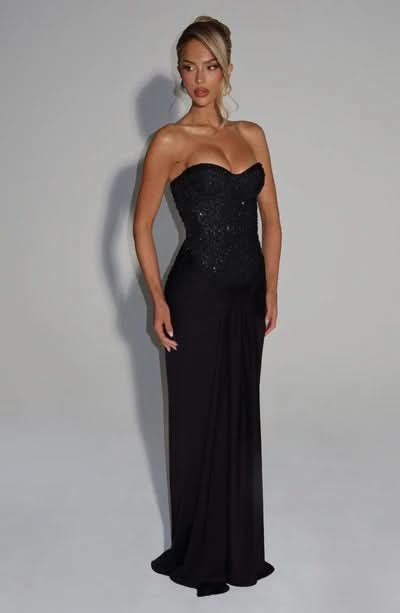 Black sequin strapless evening gown with draped maxi length skirt