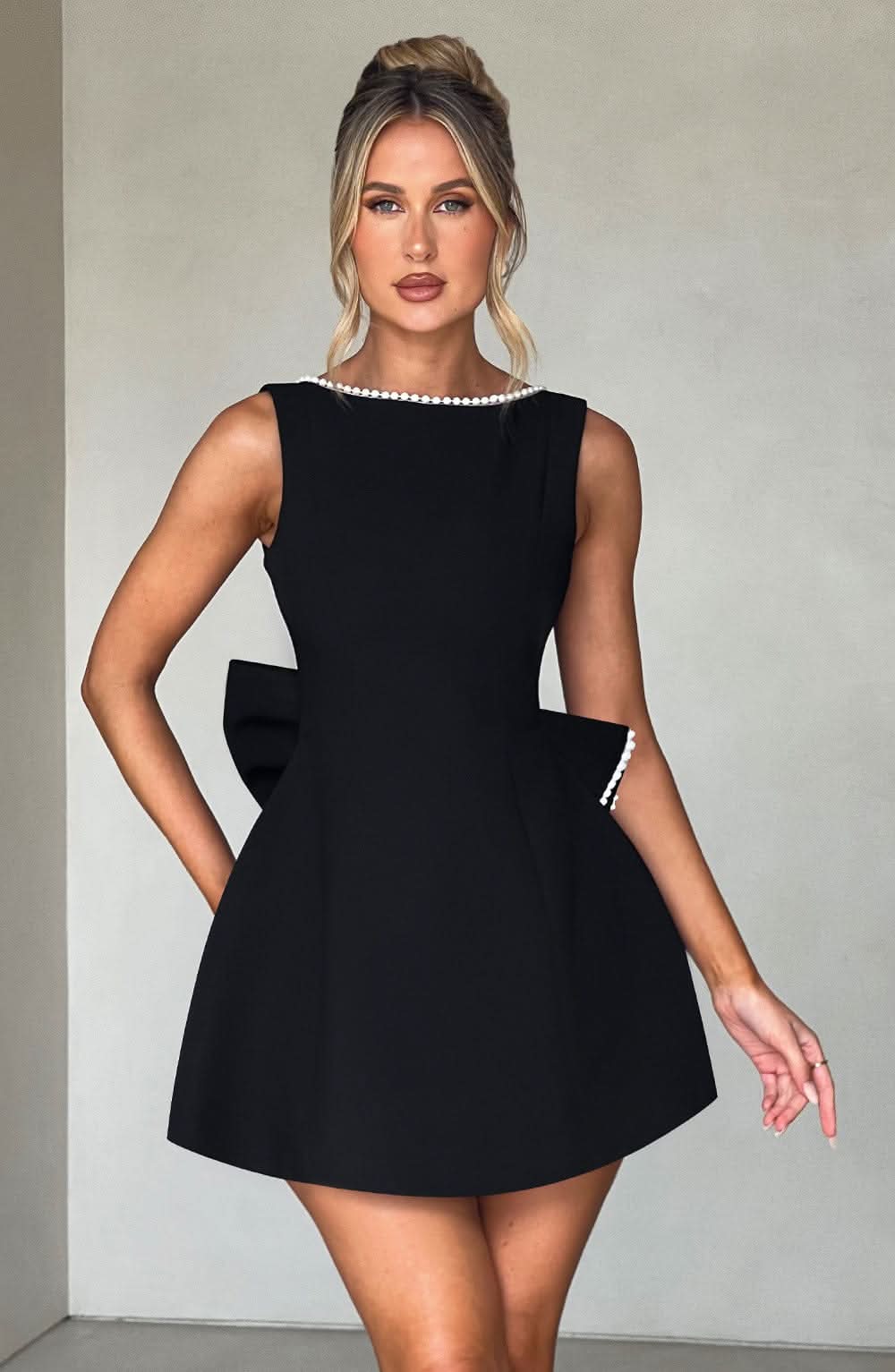 Black A-line mini dress with pearl-trimmed crew neck and structured fit