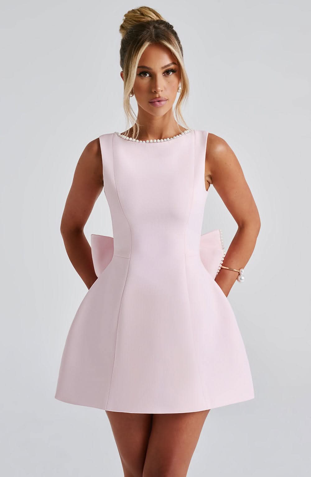 Blush pink sleeveless mini dress with pearl neckline and side pockets
