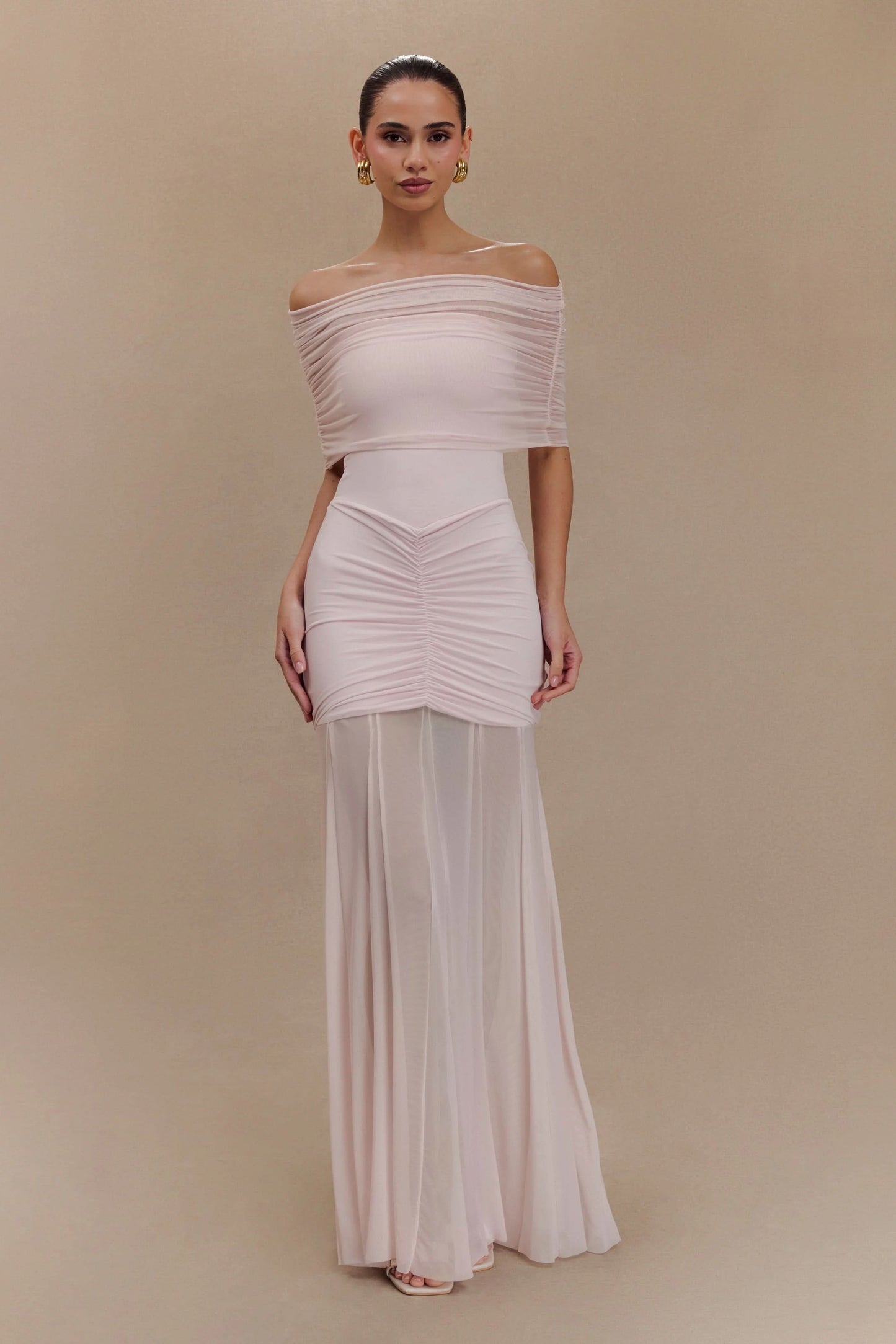 Blush pink off-shoulder maxi dress with gathered bodice and flowing hem
