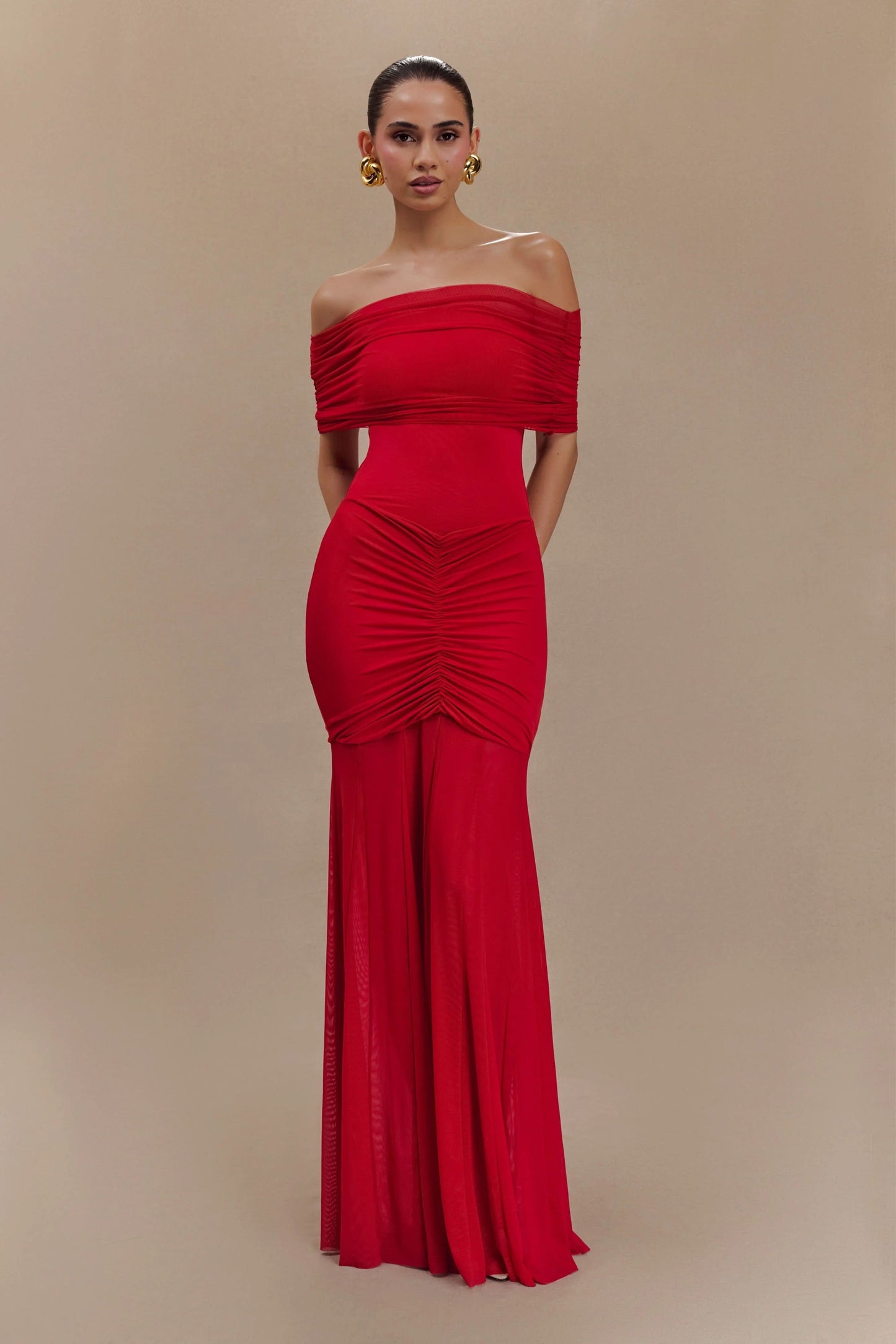 Red off-shoulder maxi dress with ruched bodice and flowing skirt