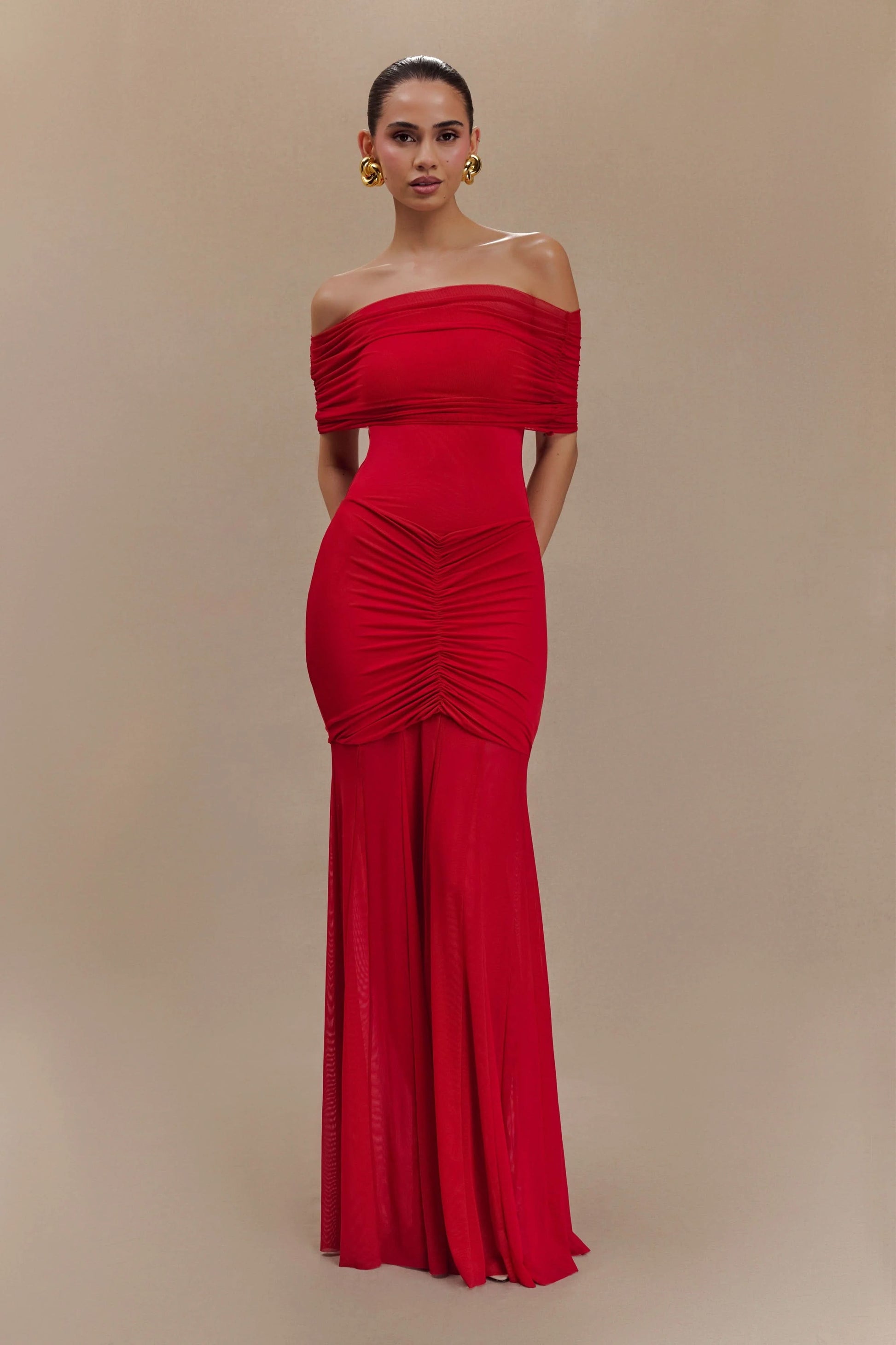 Red off-shoulder maxi dress with ruched bodice and flowing skirt