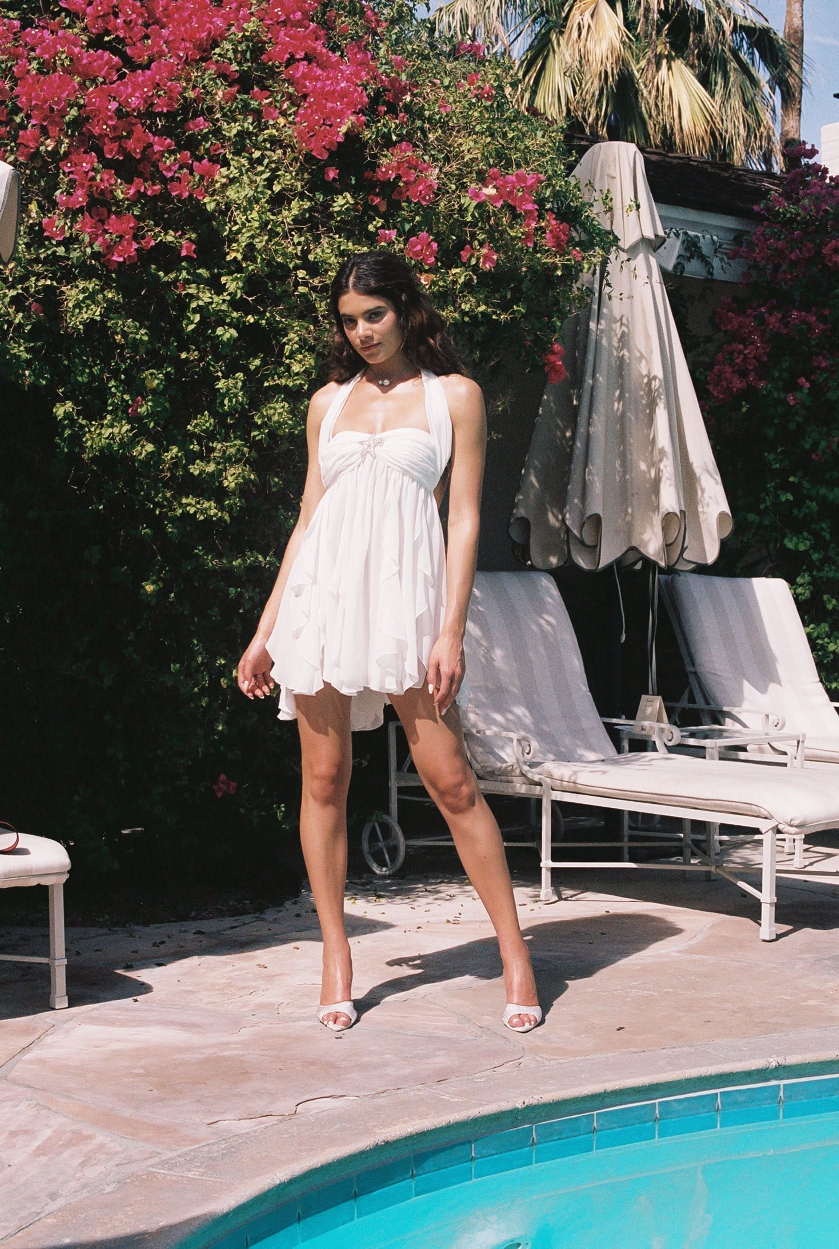 White halter mini dress with gathered bust and layered handkerchief hem detail