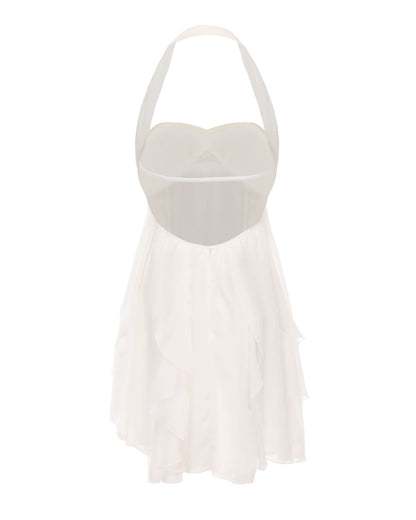 Back view of white halter mini dress showing open back cutout design