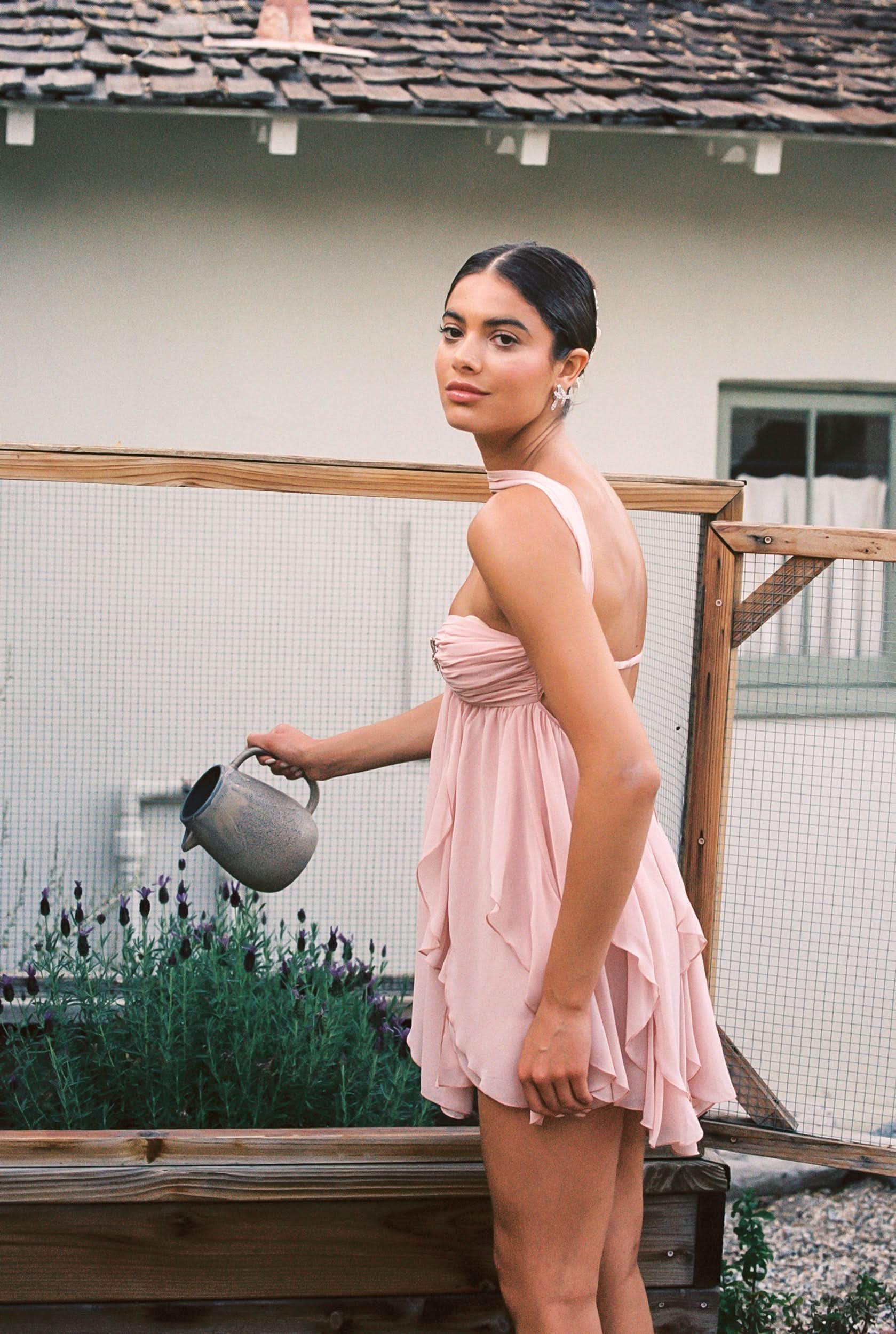 Blush pink halter mini dress back view with draped ruched waist detail