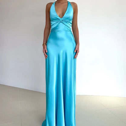 Turquoise halter maxi dress with twisted front bow and flowing floor-length skirt