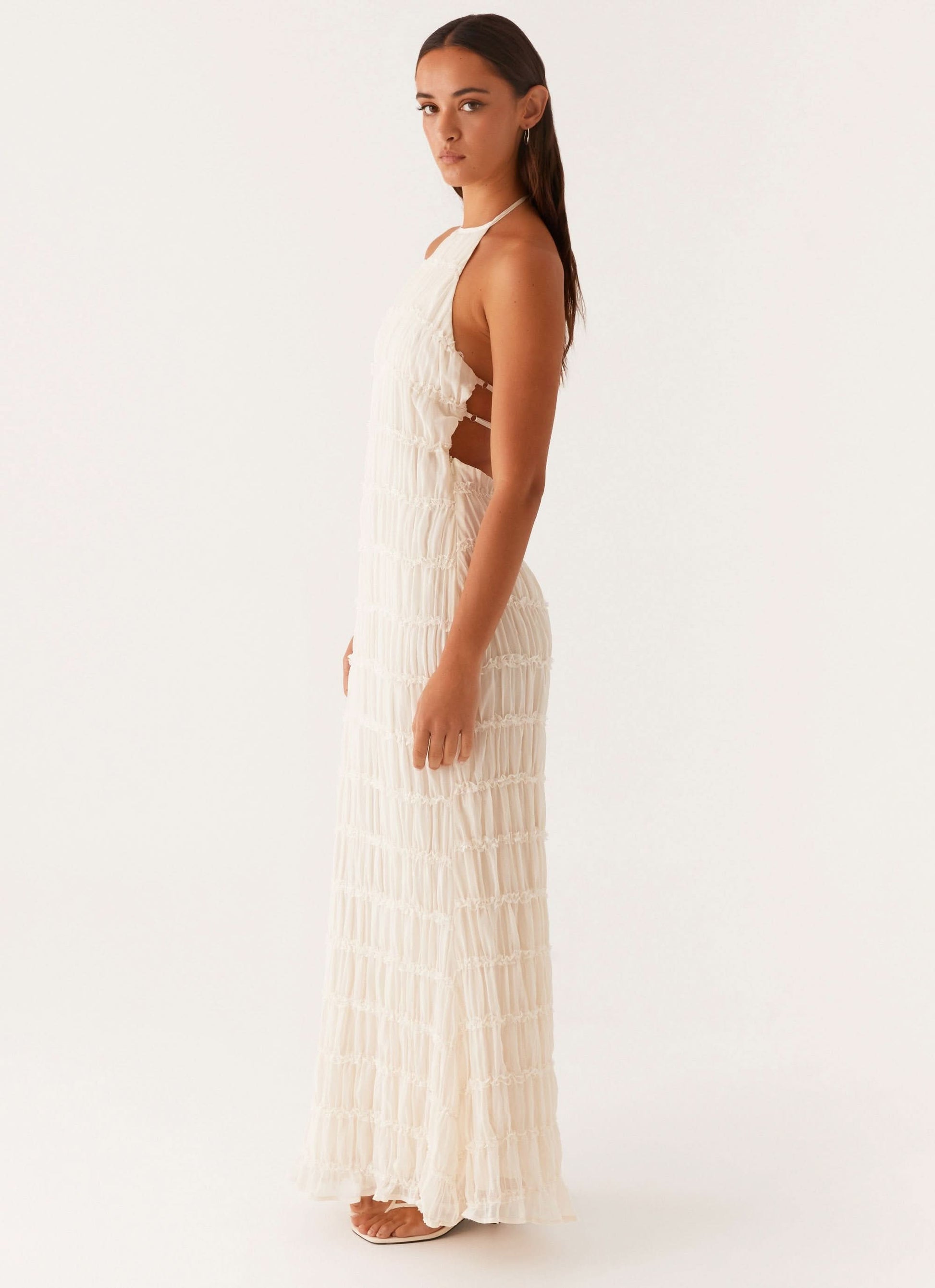 Back view of yellow pleated maxi dress with double strap cutout
