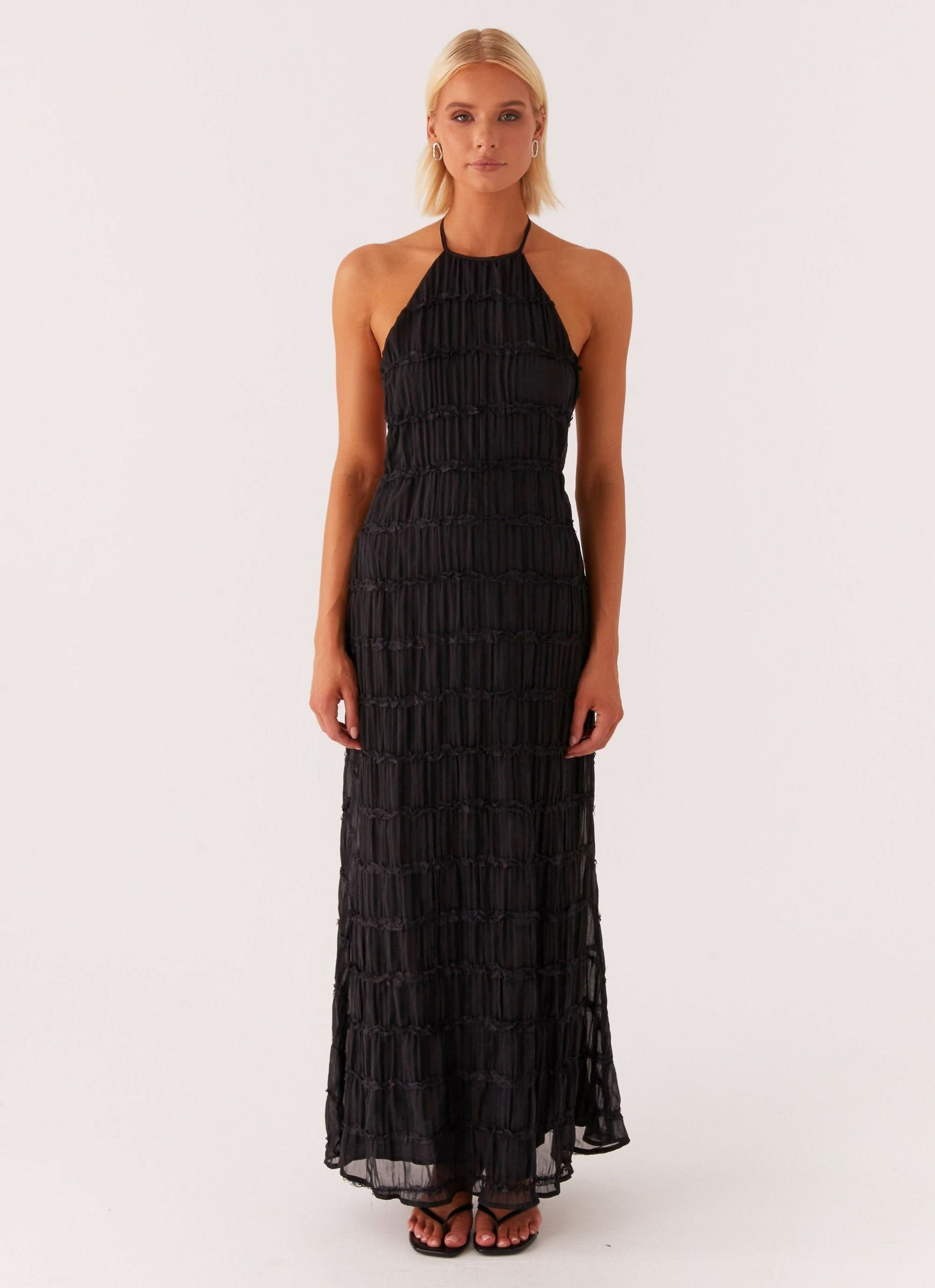 Black pleated halter maxi dress with layered ruffle skirt detail