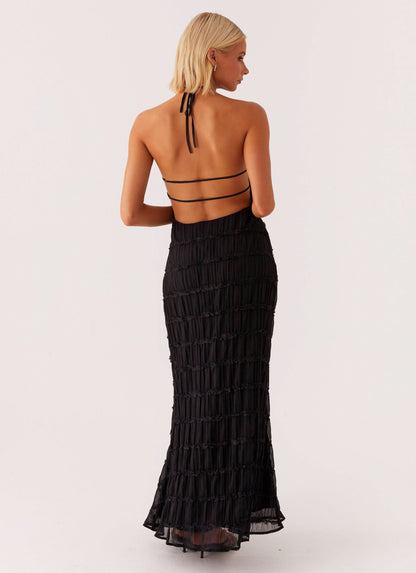 Back view of black pleated maxi dress with strappy cutout details