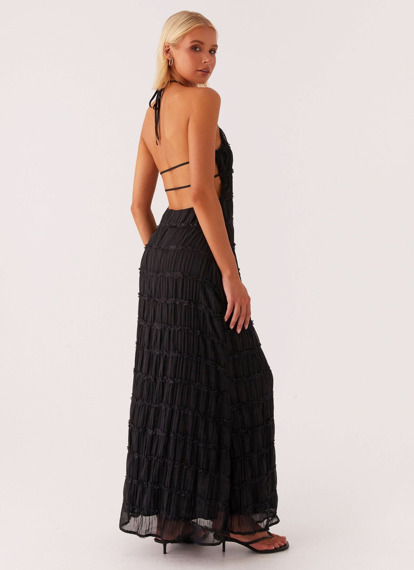 Back view of black pleated maxi dress with double strap cutout