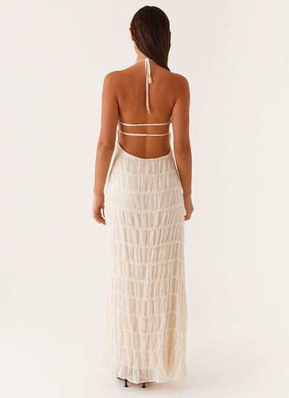 Back view of cream pleated maxi dress with double strap cutout